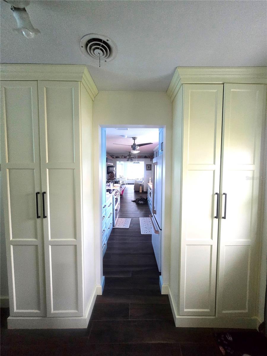 Hallway from garage to kitchen. Laundry storage