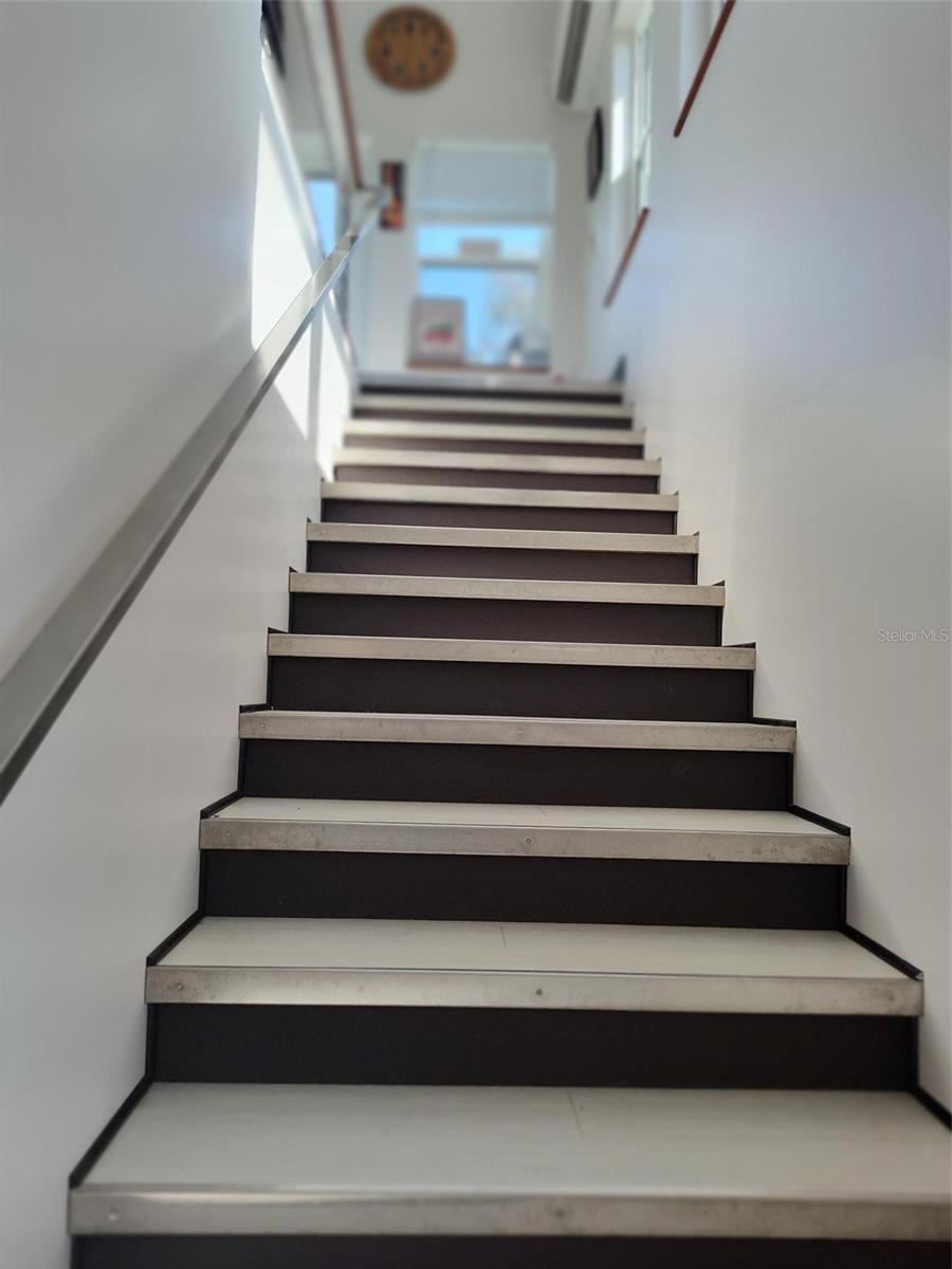 Stairway to second floor. Custom metal accents.
