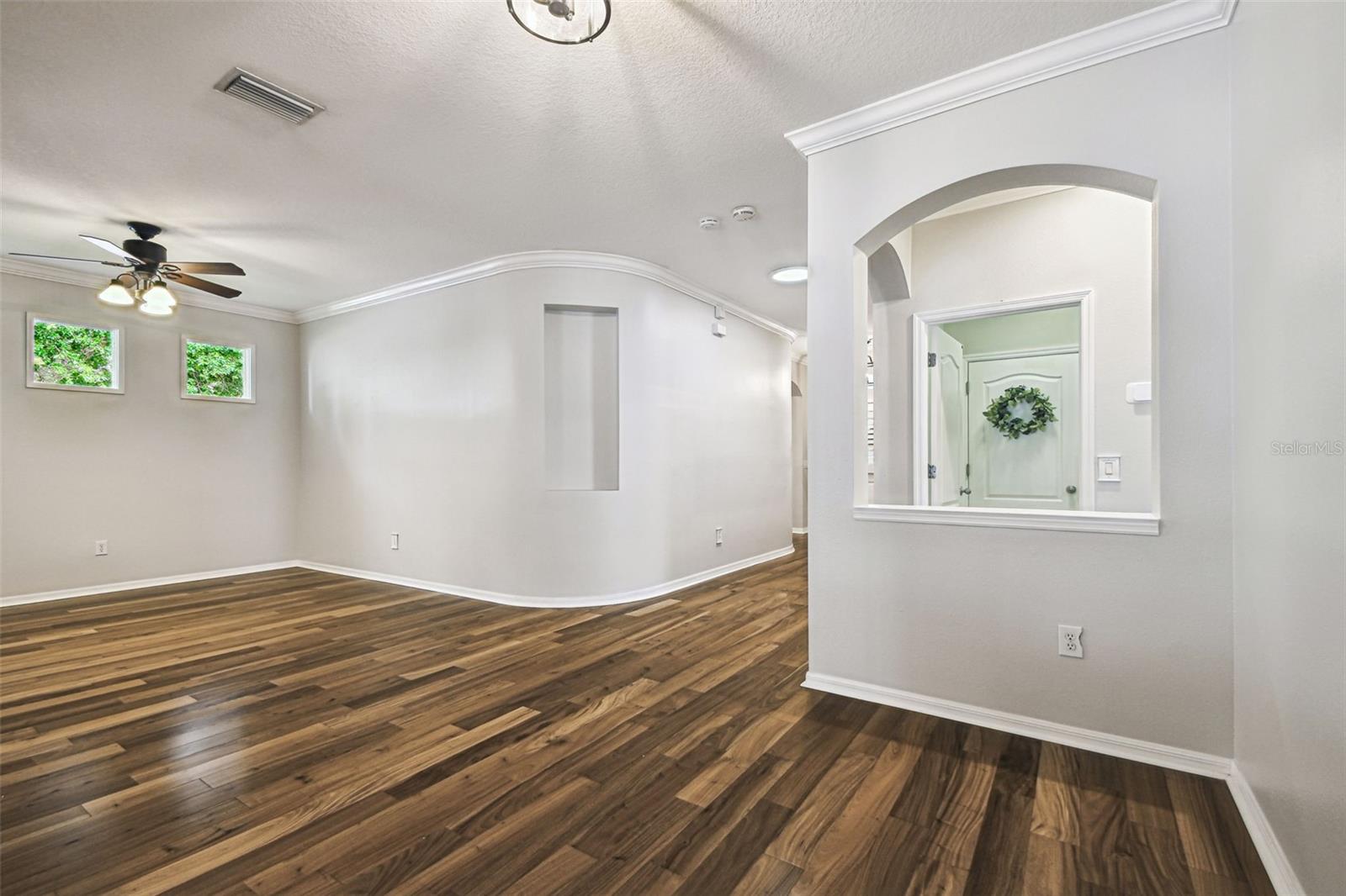 Formal rooms looking back towards foyer. Laundry room in distance with wreath on door