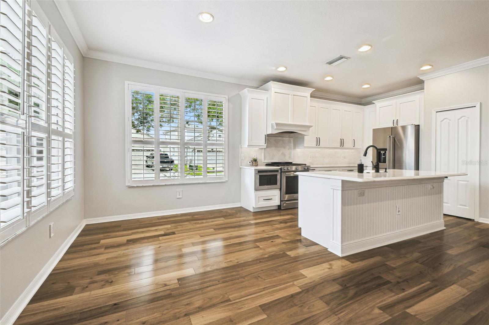Casual dining with windows to backyard/pool