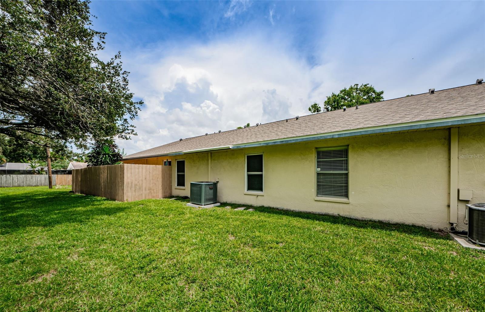 Here is the back yard where you could possibly create an outdoor patio as the neighbors have done.  Needs HOA approval.