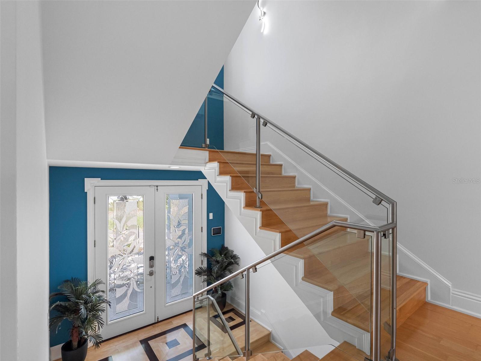 Stairs lead to third floor with three more bedrooms.