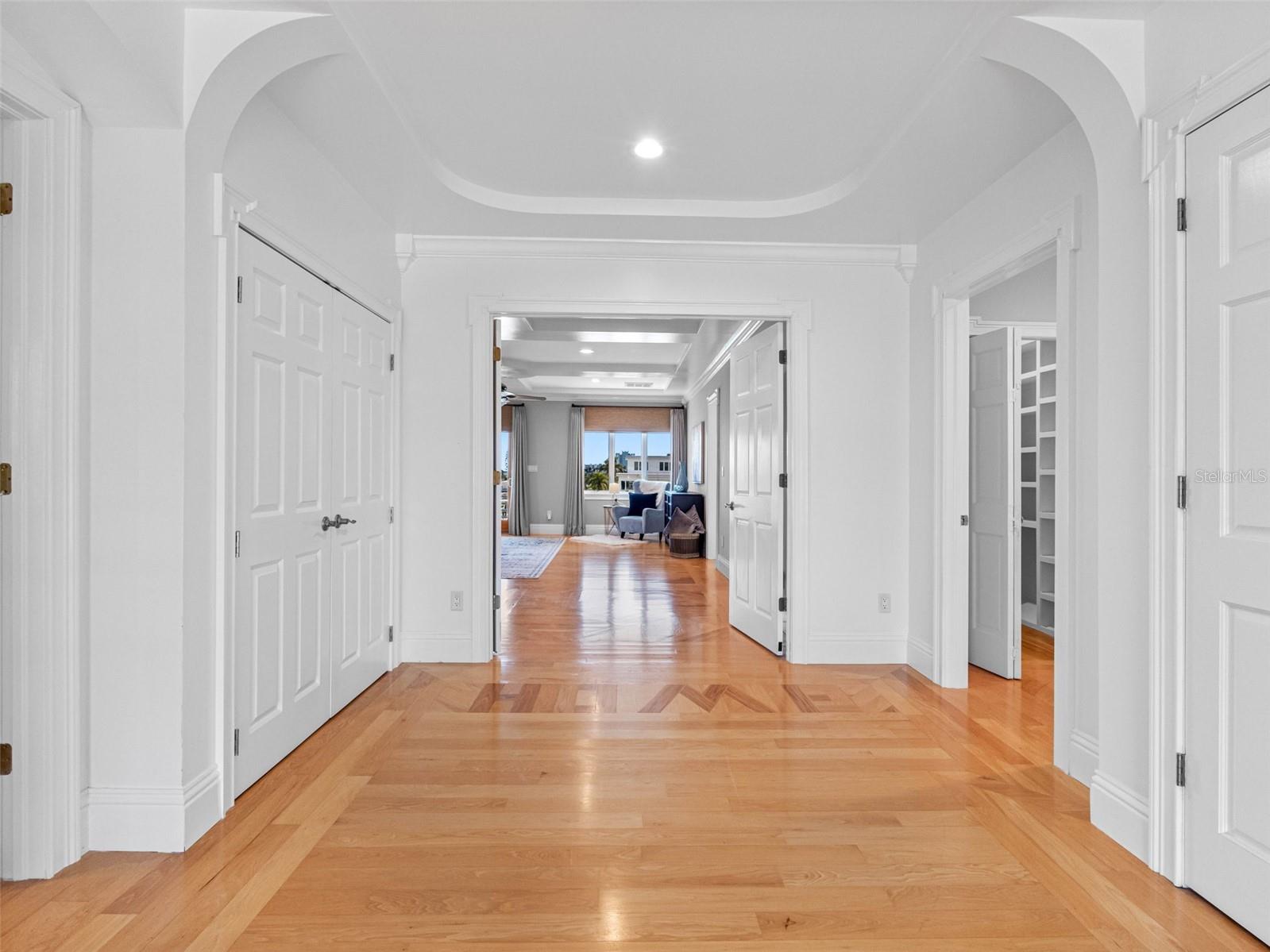 Welcoming hallway with gleaming wood floors.