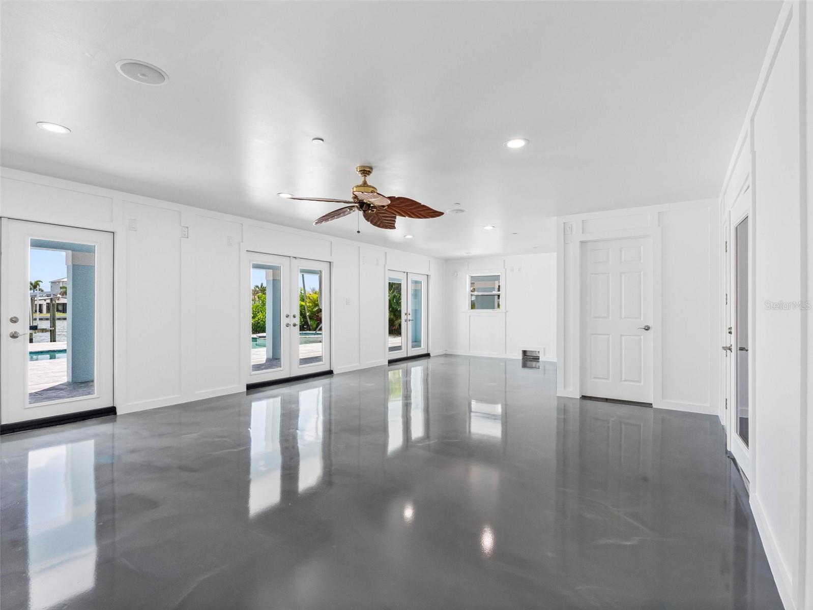 Bonus room with Hardie board walls opens to covered lanai and pool.