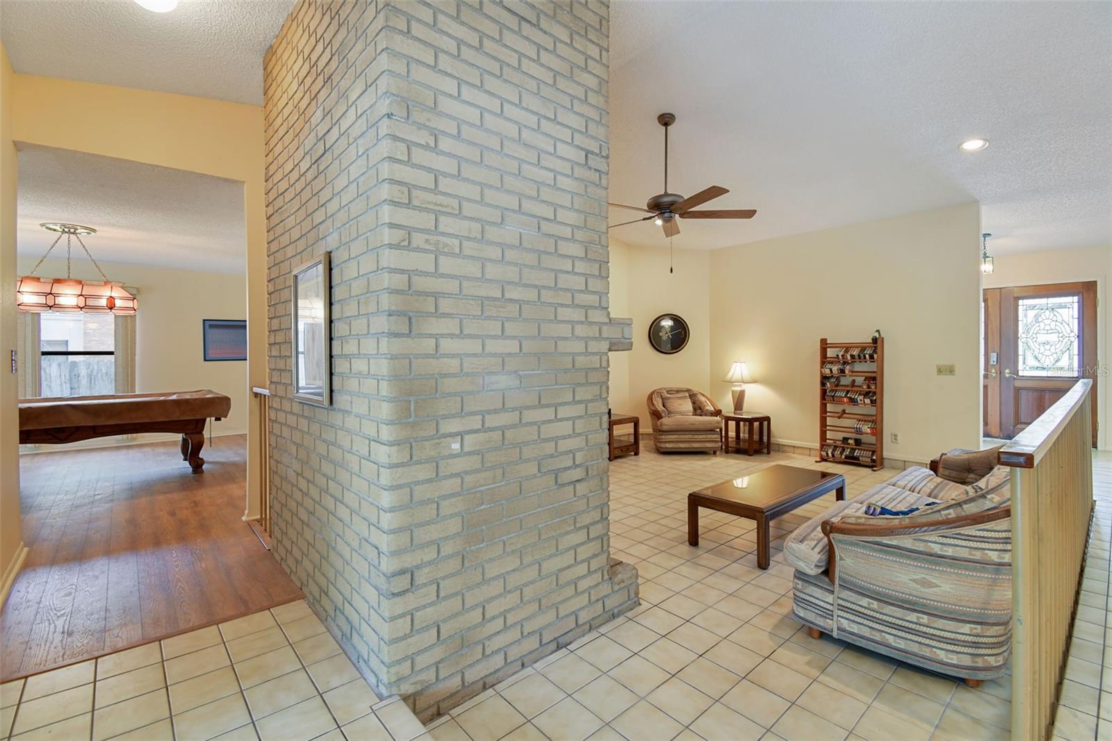 Family Room w/Brick Fireplace & Hallway to Bonus Room