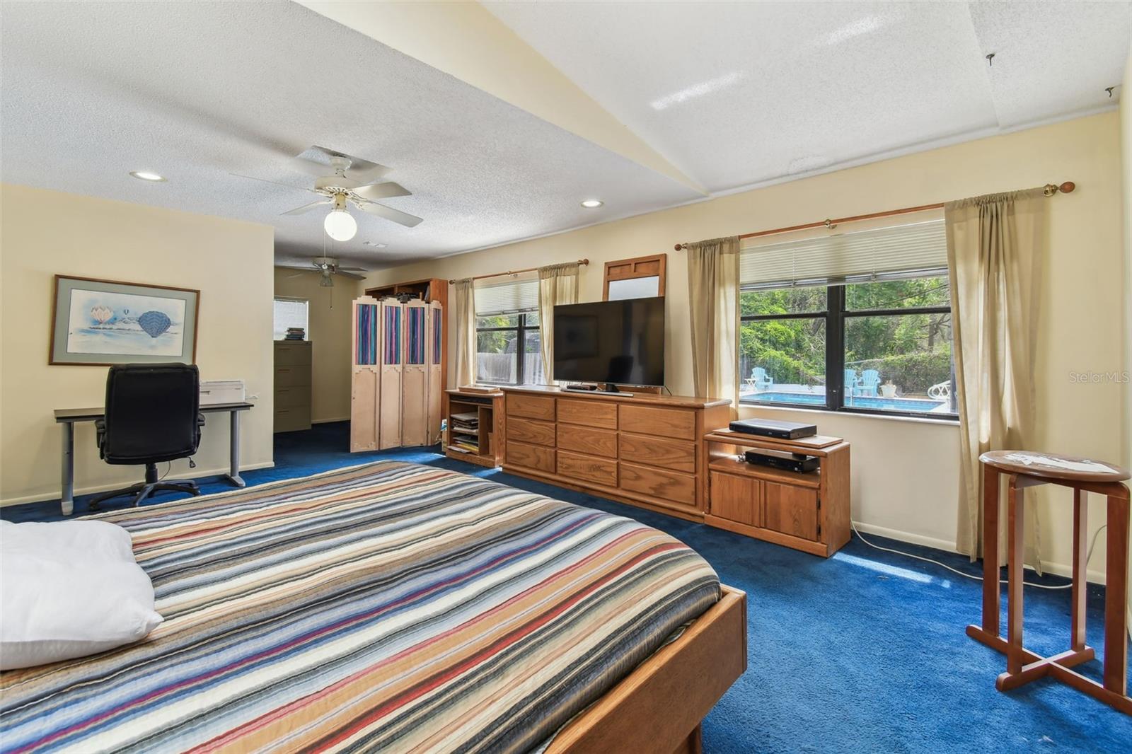 Primary Bedroom w/views of Pool & Yard