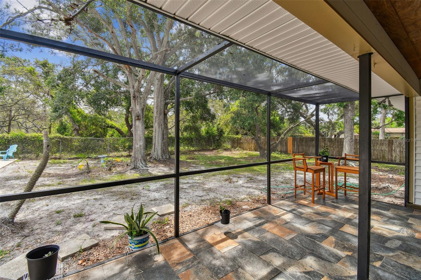 Covered/Screened Lanai wth view of yard