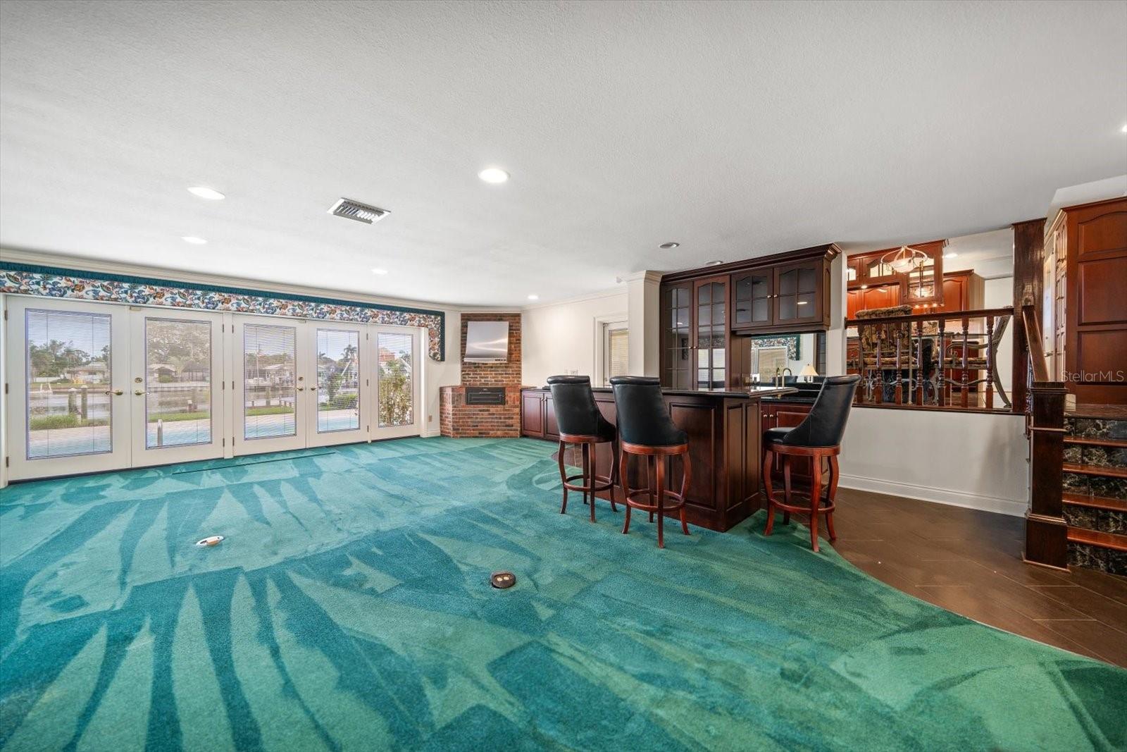 Oversized family room, bar, indoor grill and a fireplace that all opens to the pool and waterfront