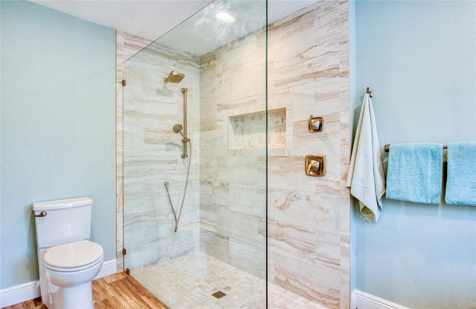 Primary en-suite bathroom features a relaxing soaking tub and a spacious walk-in shower, offering the perfect blend of comfort and functionality.