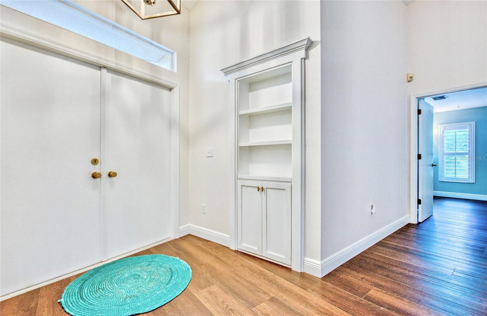 A hidden doorway, cleverly disguised as a built-in bookshelf, provides a fun and private entrance to the fourth bedroom—adding charm and a touch of mystery.