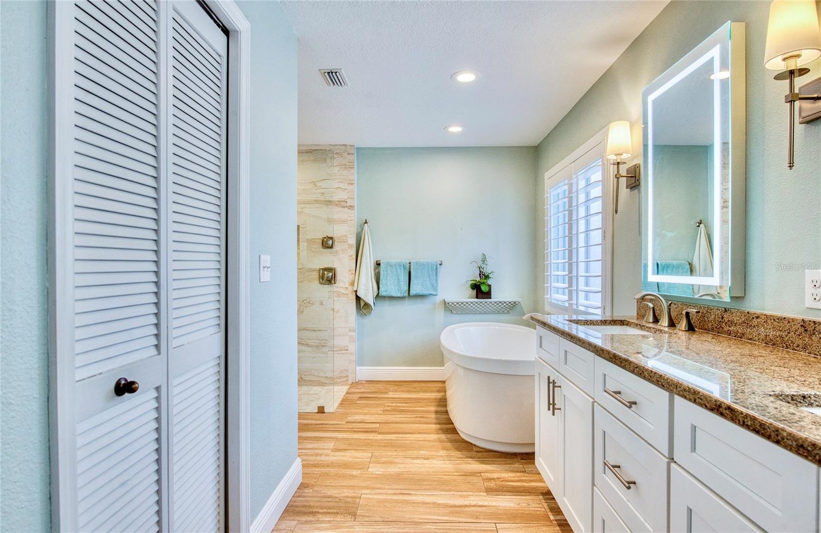 The spacious primary en-suite bath offers a luxurious soaking tub and a large walk-in shower, all beautifully bathed in natural light—creating a serene, spa-like retreat.