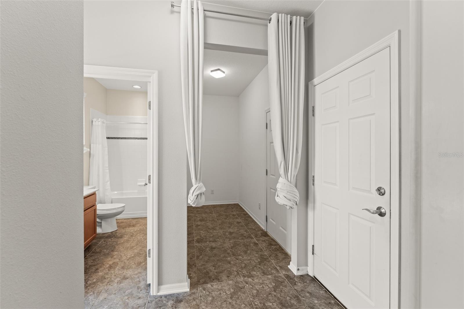 Full bath and extra room for storage with access to the gym.