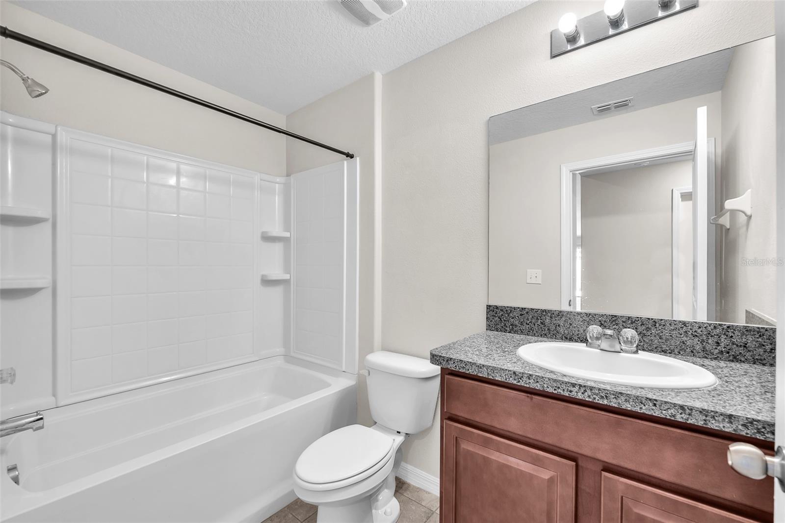 Full guest bathroom shared by 2 secondary bedrooms contains a bathtub/shower combination.