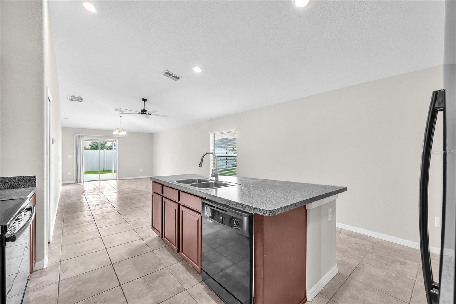 The kitchen has a seamless connection to the Living room.