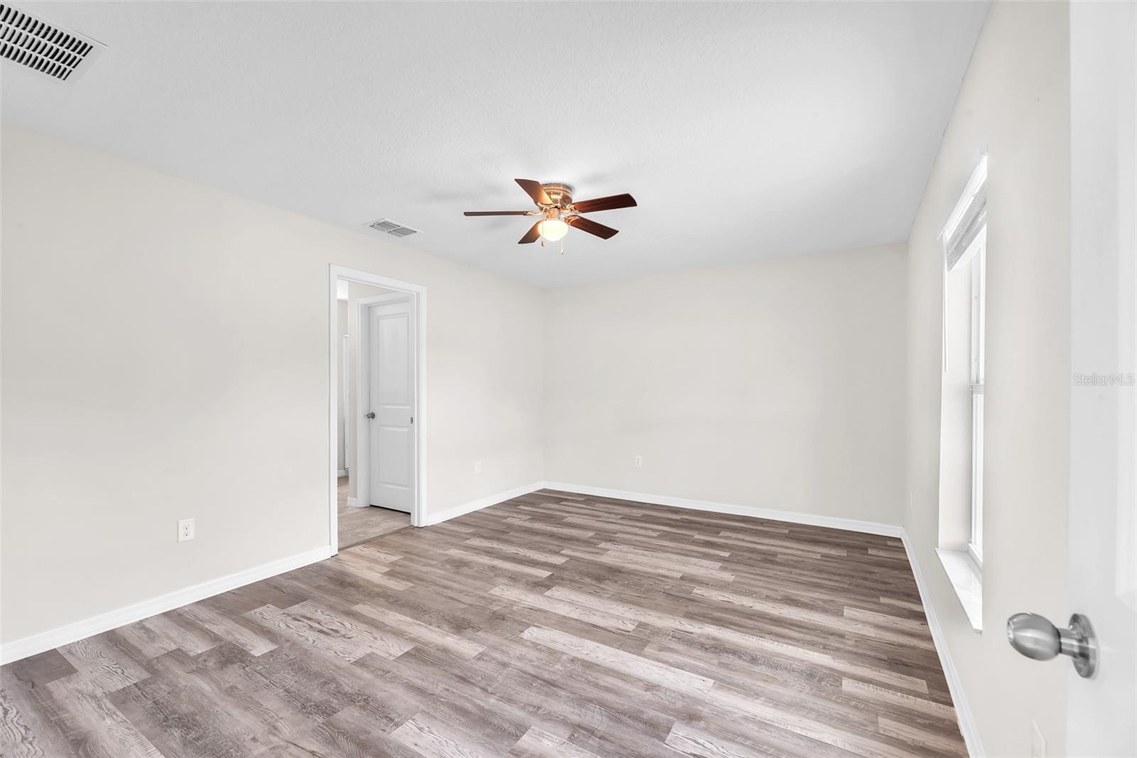 Primary Suite with walk-in closet and ensuite bathroom.