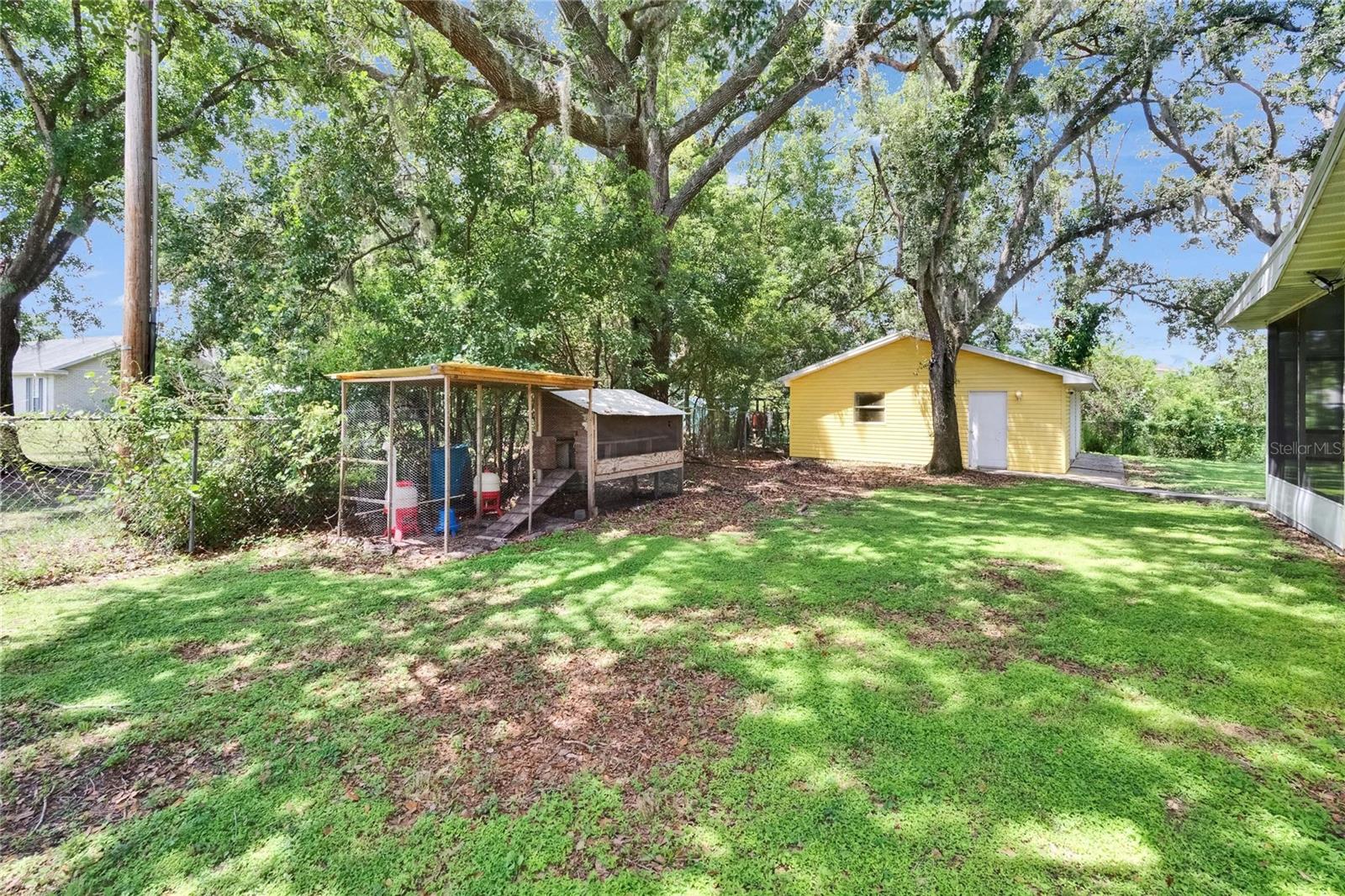 South side of home ( left side) When looking from the front.  Chicken coop ( included).  Detached Large two car Garage/workshop/office/ home school ( AC and electric)