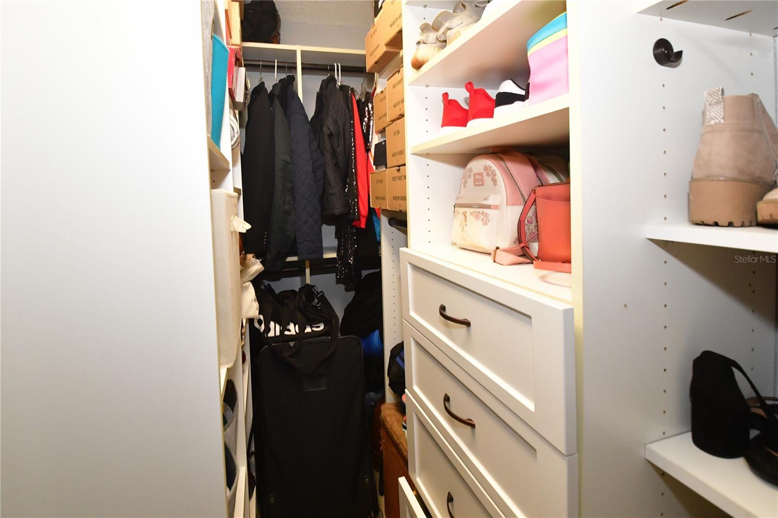 Walk in closet with California closet system