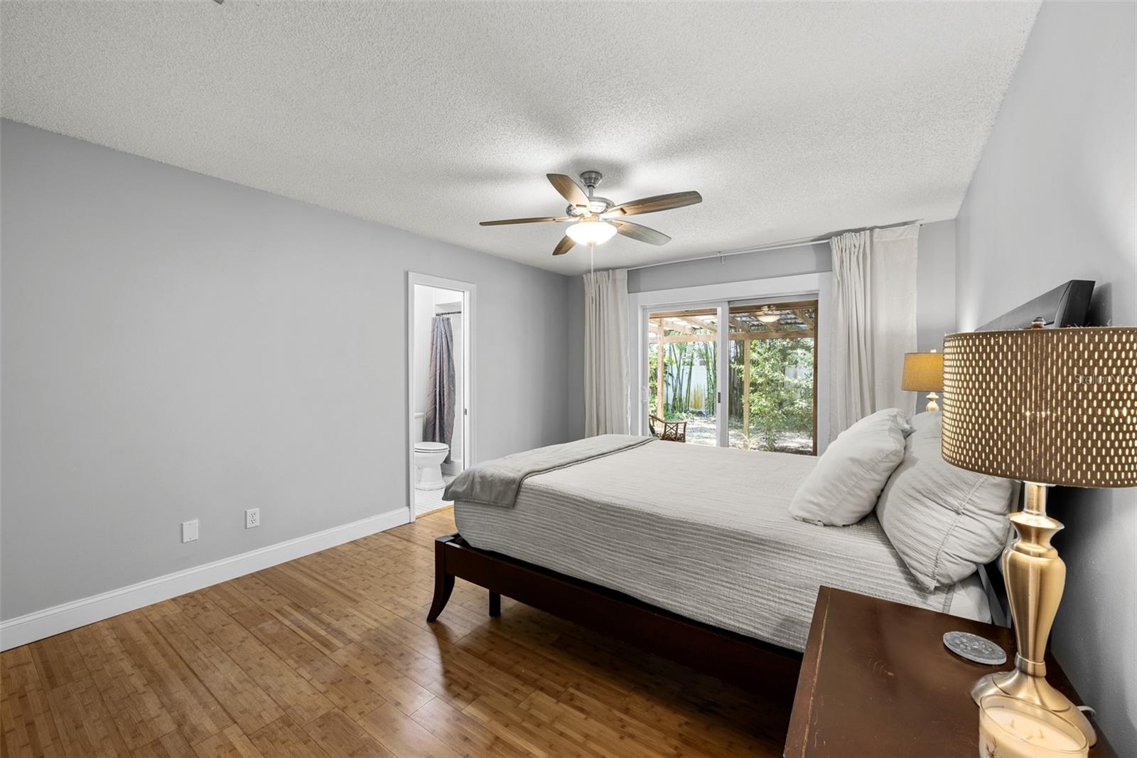 Primary Bedroom w/ Direct Access to the Covered Lanai and Tranquil Backyard