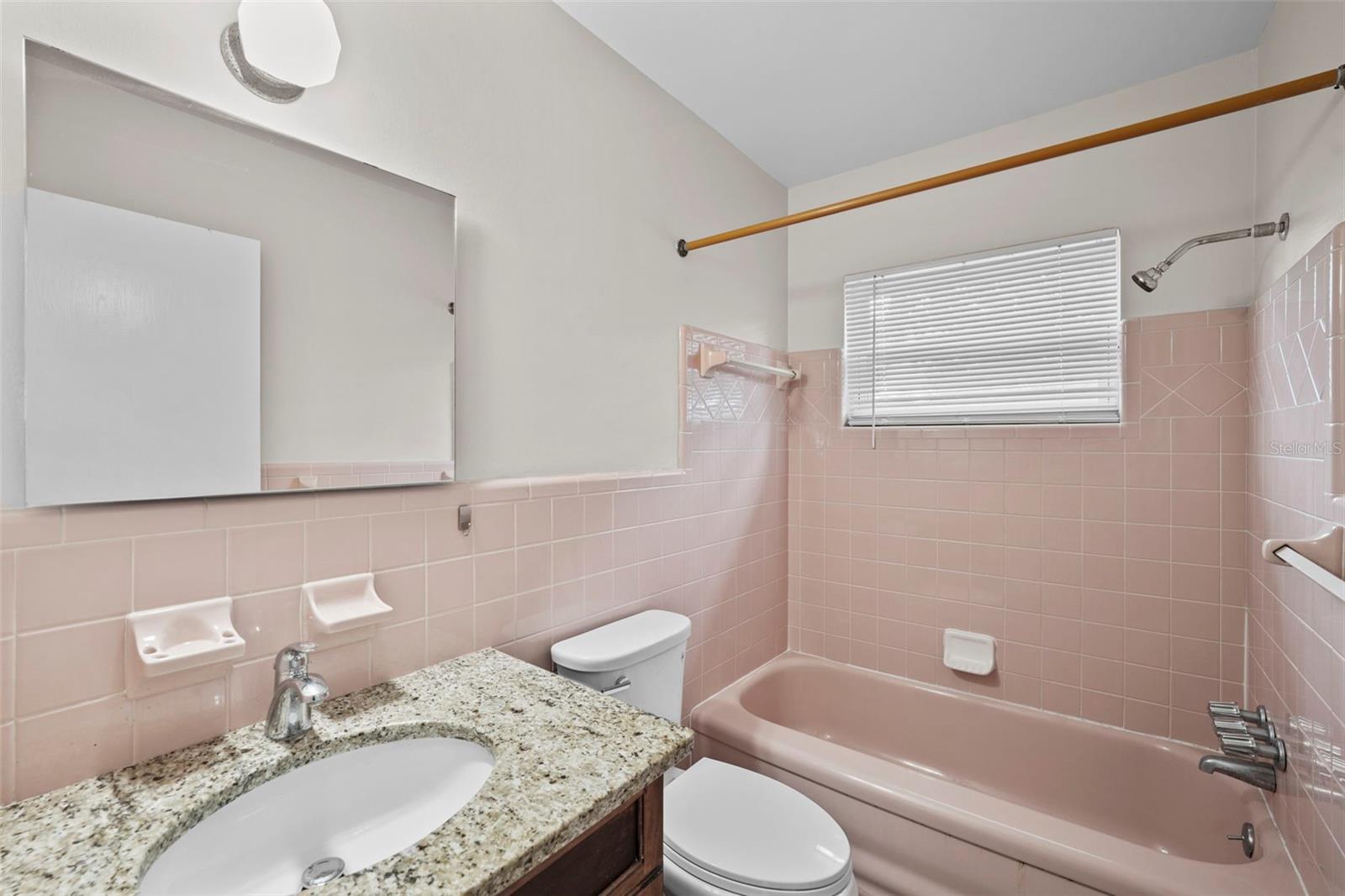 Absolutely beautiful mid-century tile and an updated vanity with mirror.