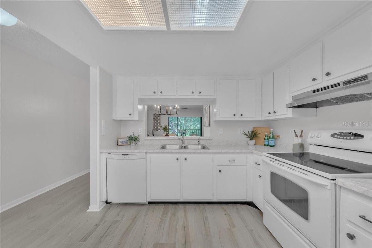 Open kitchen with pass through to stay connected with family, friends and guests