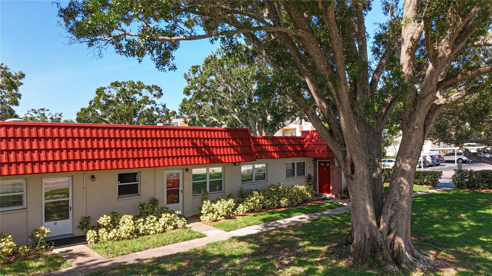 Deeded parking space #44 is shaded by oak trees and just steps from the front door.