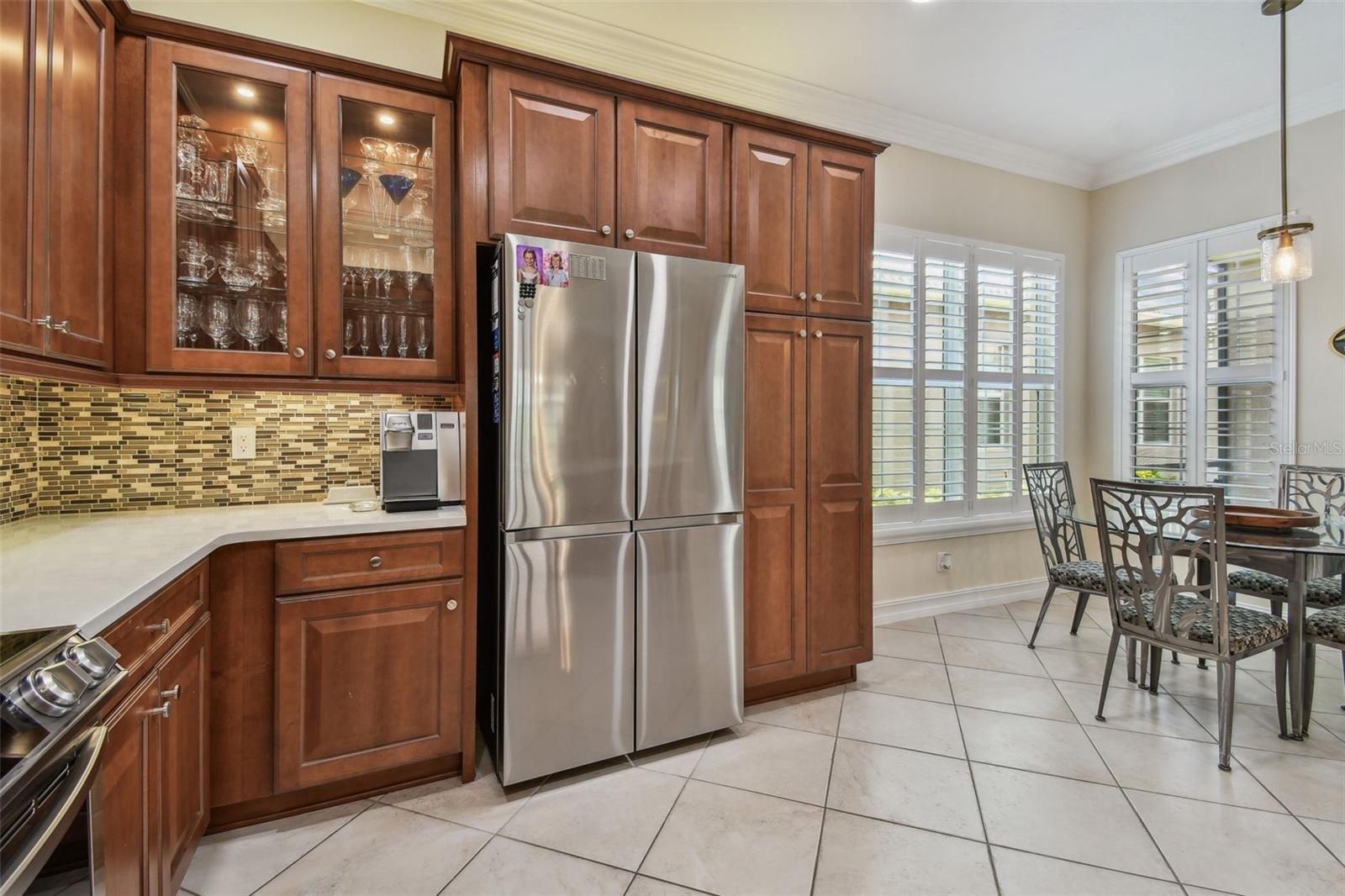 Custom features such as glass transoms in the cabinets makes this kitchen special