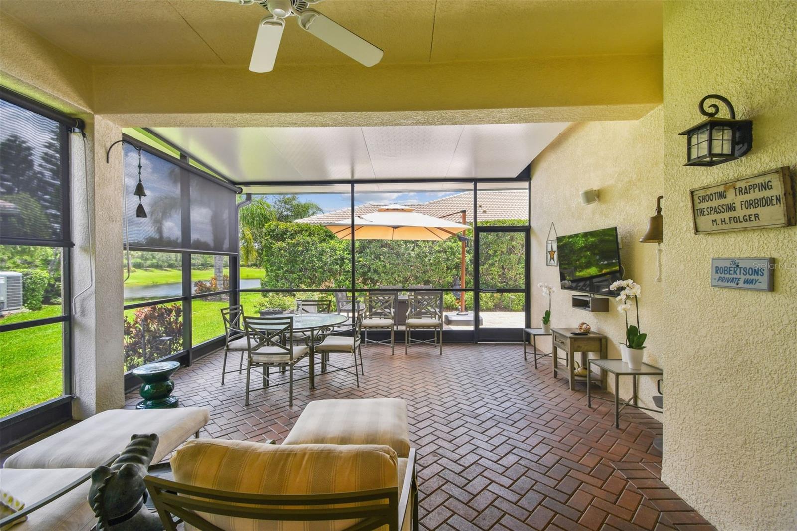 Extra large extended covered lanai with custom pull down shades ($1600 each) is perfect for cool nights to dine and watch TV outdoors- all with a pond view!