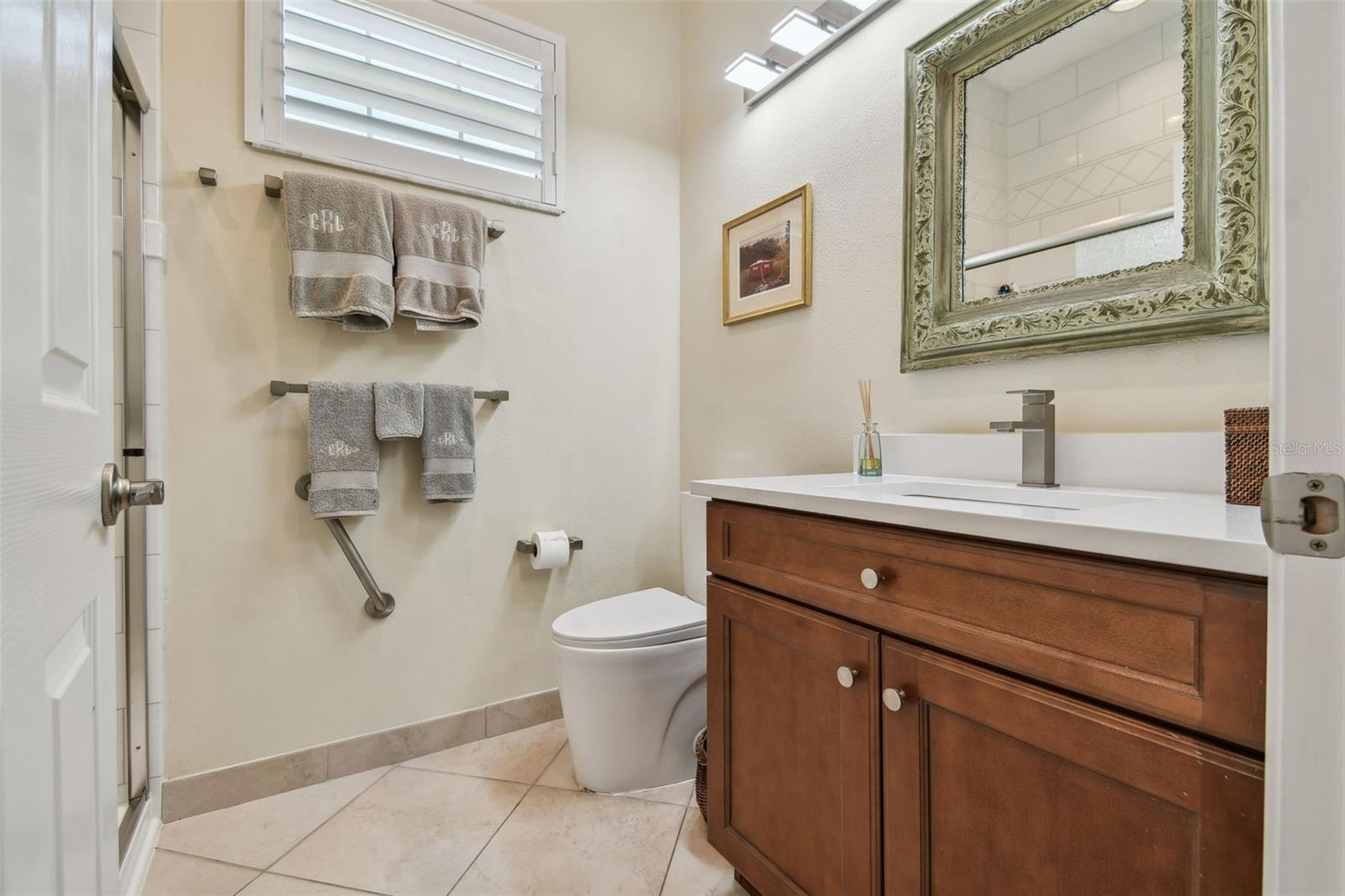 Secondary bath has recently undergone a full $16,000 renovation with new shower tile, shower enclosure, quartz counters, plumbing fixtures, and lighting