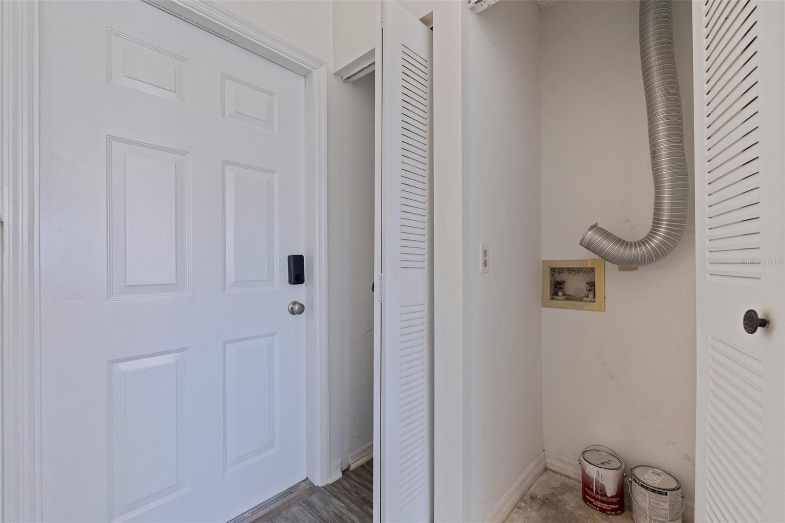 Front door with coat closet and laundry closet for stackable washer / dryer hookups