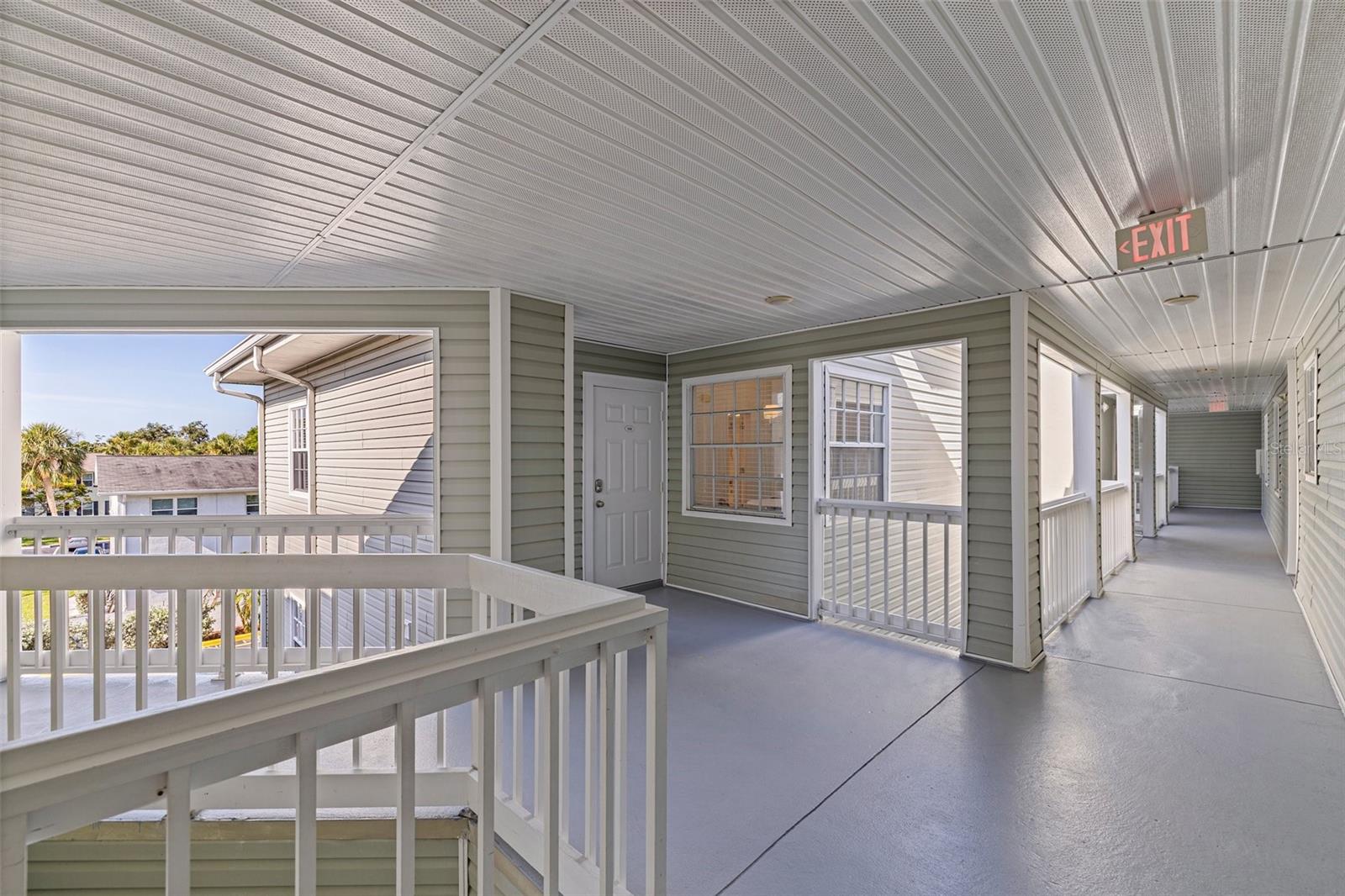 Front entrance with front door and hallway to elevator in view