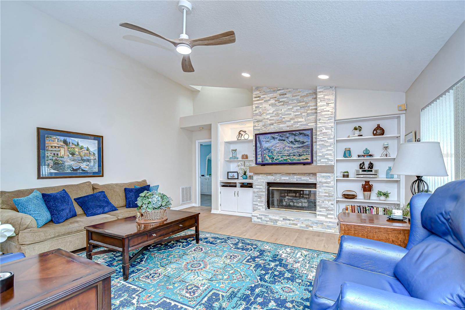 Family room boast fireplace built in shelving and lots of natural light