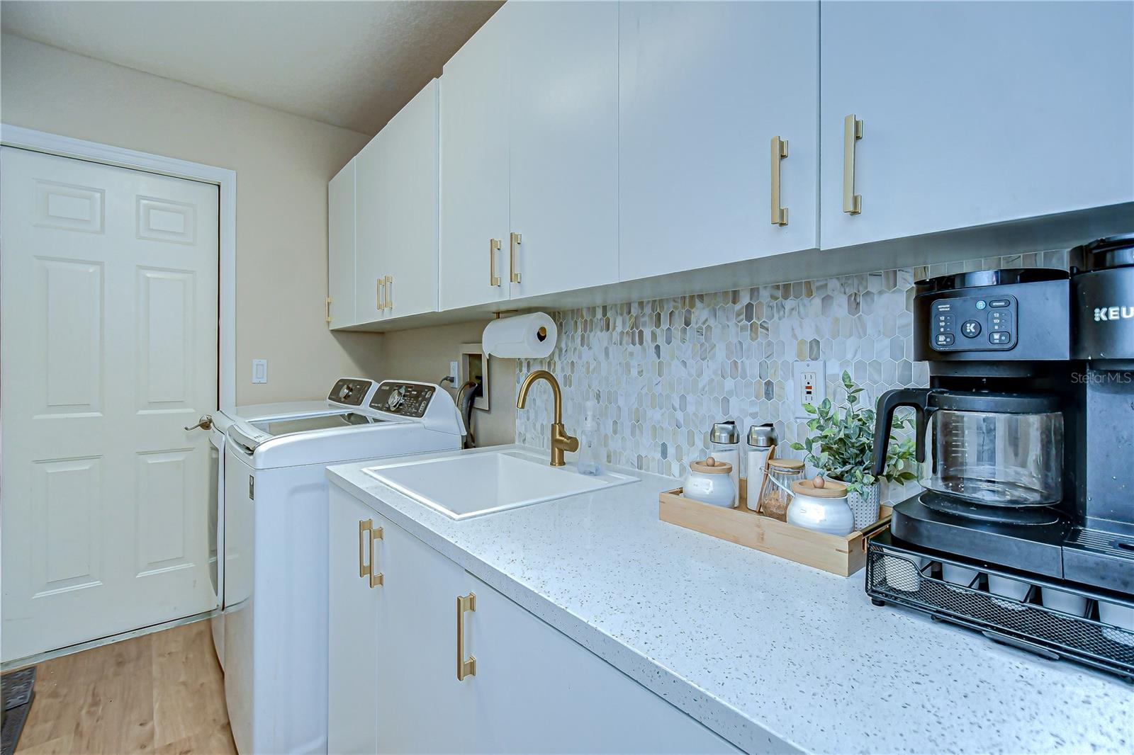 Large Laundry Room with Quartz countertop and Lots of storage cabinets