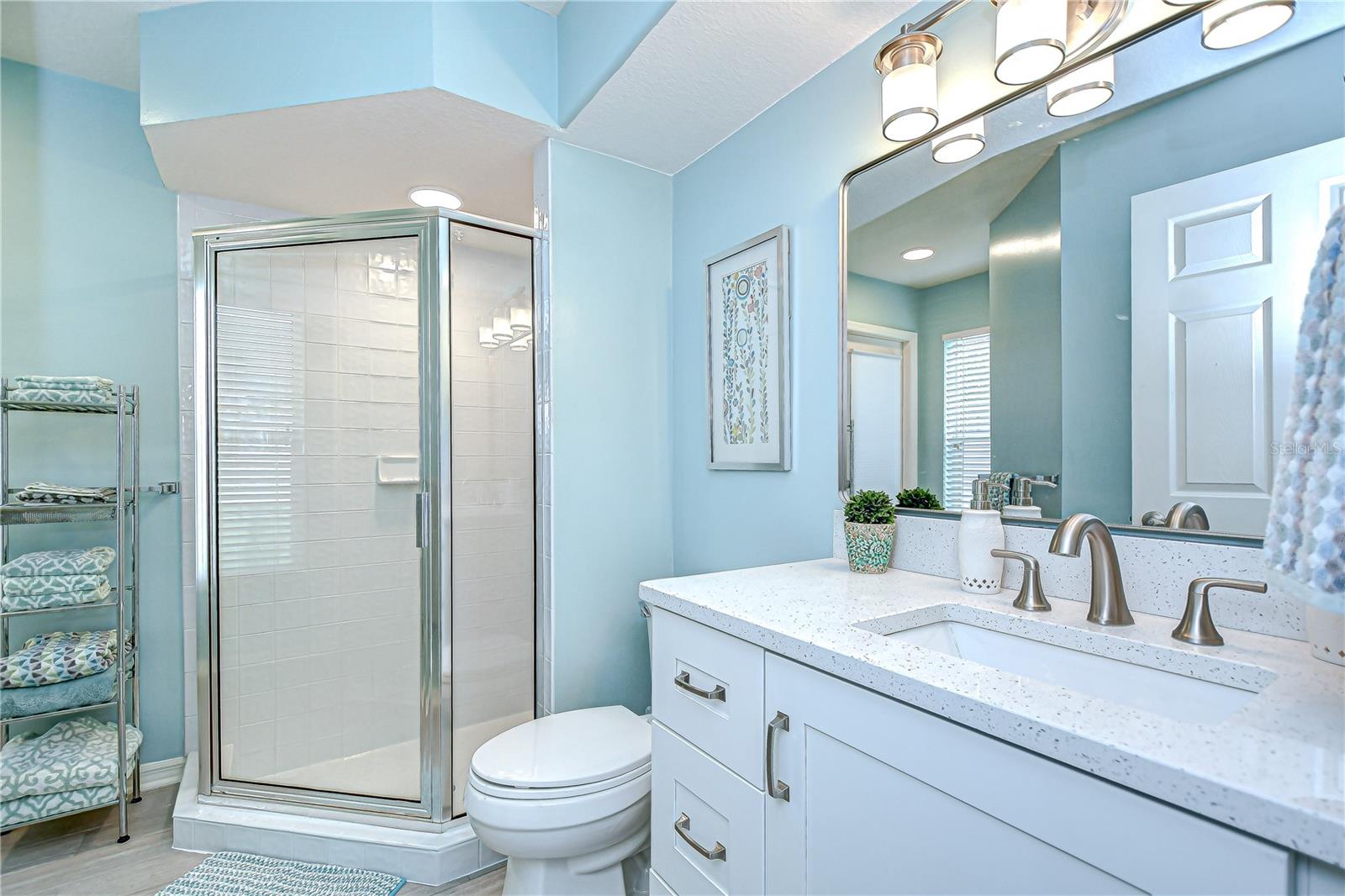 Ensuite (Bathroom#3)with shower, quartz countertop, & linen closet.