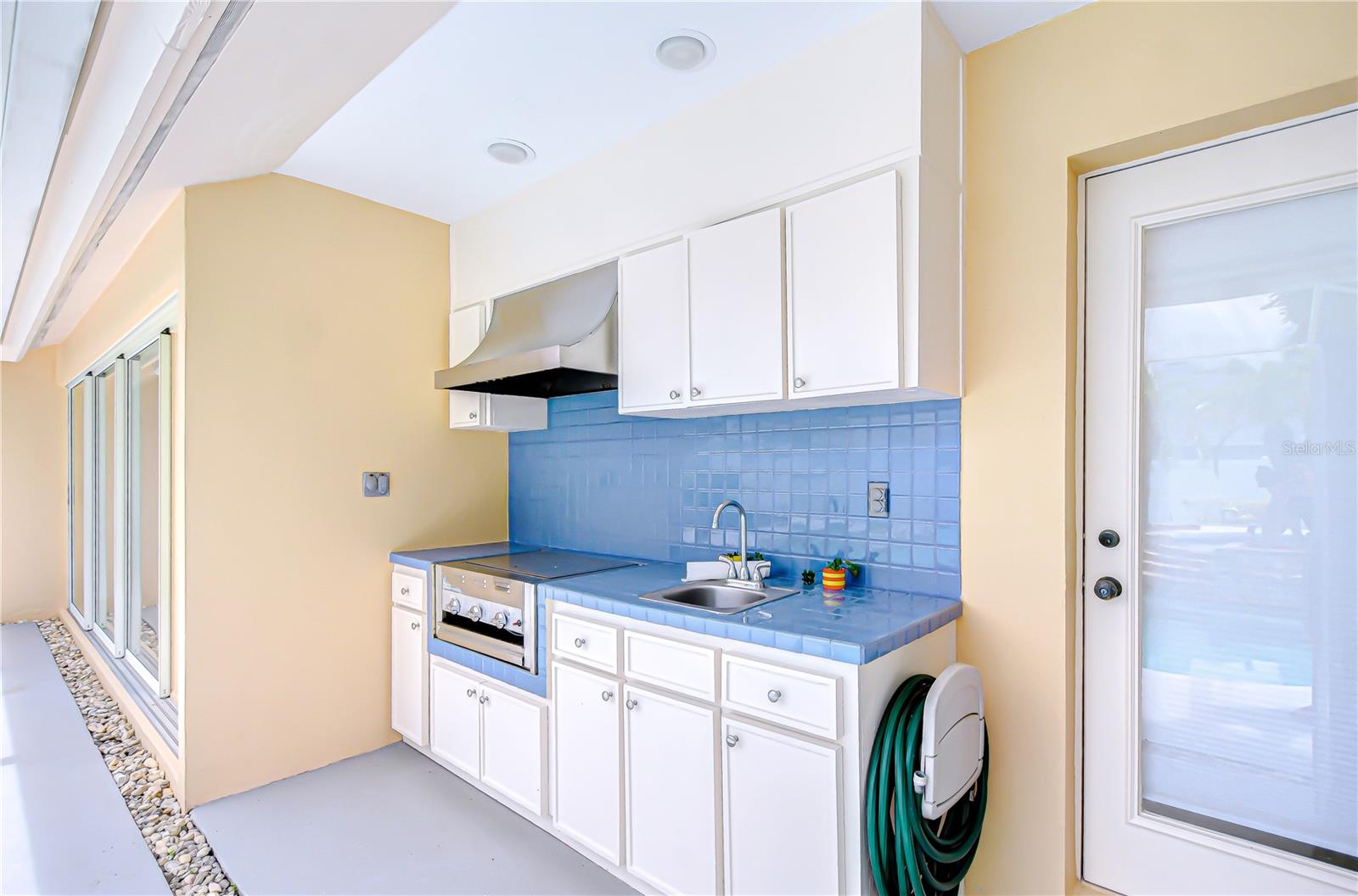 Built in kitchen with grill and sink.