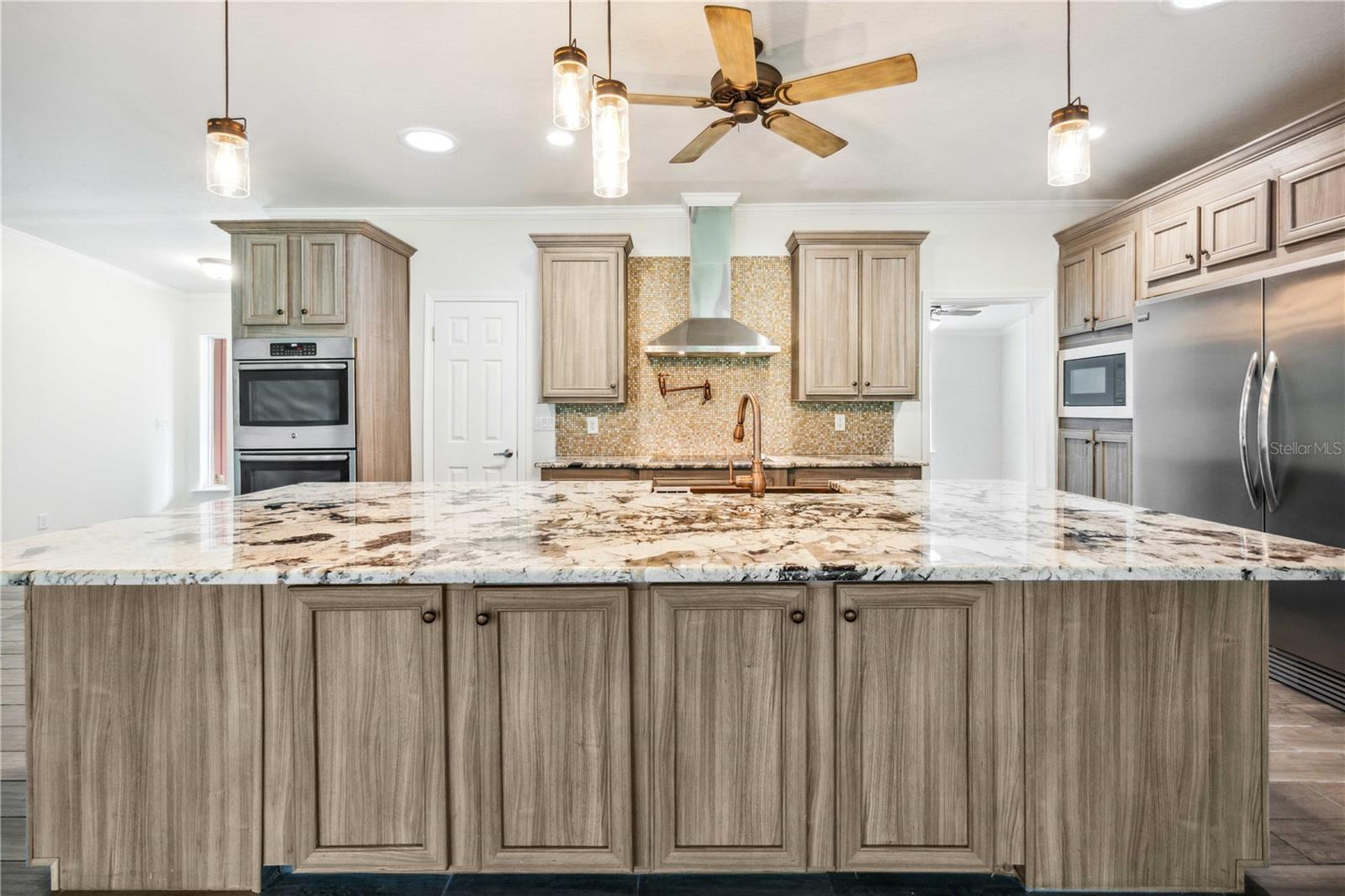 Well-appointed kitchen island offers abundant cabinetry and workspace.