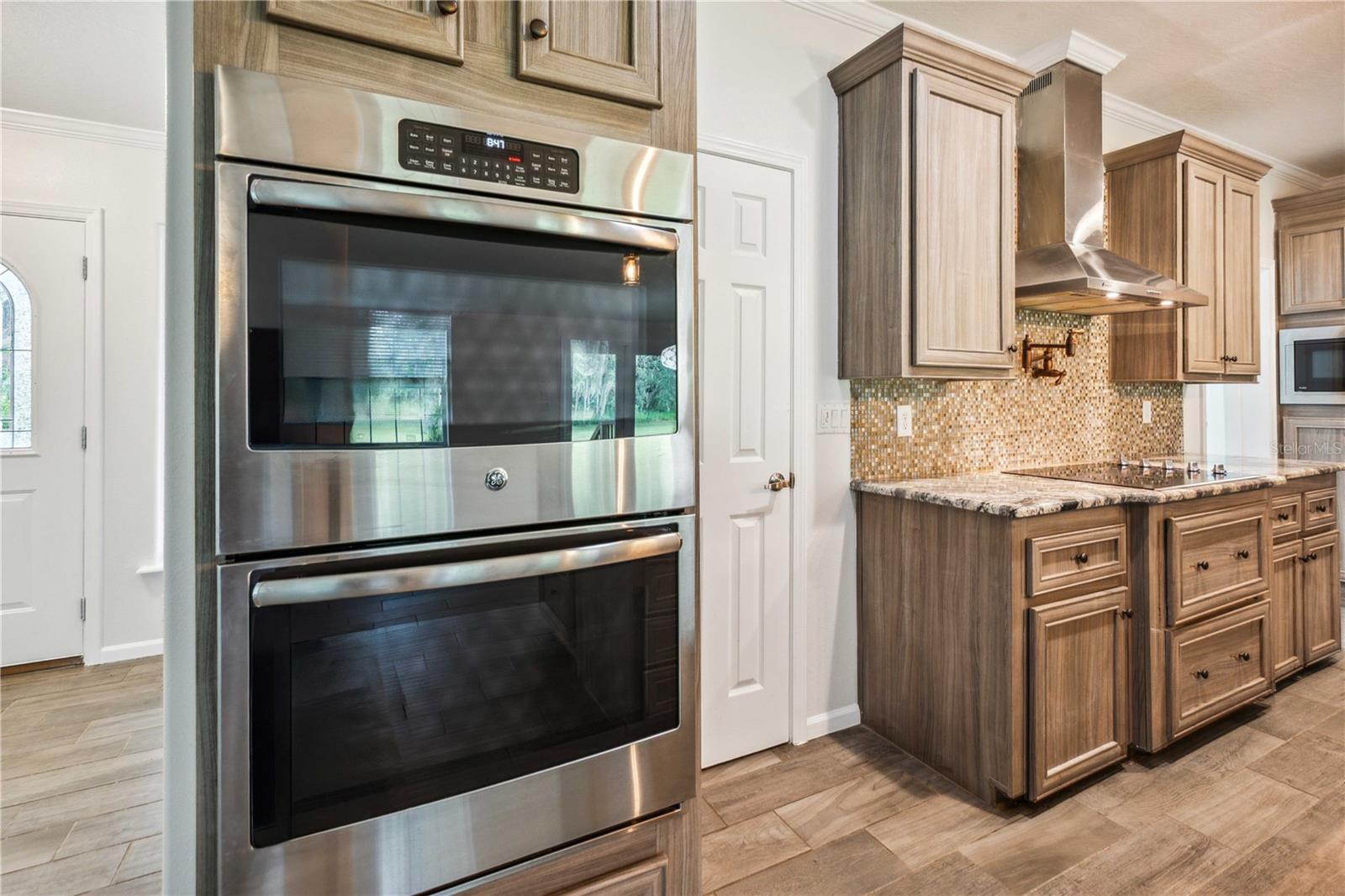 Chef’s kitchen features double stainless steel ovens and coordinating appliances.
