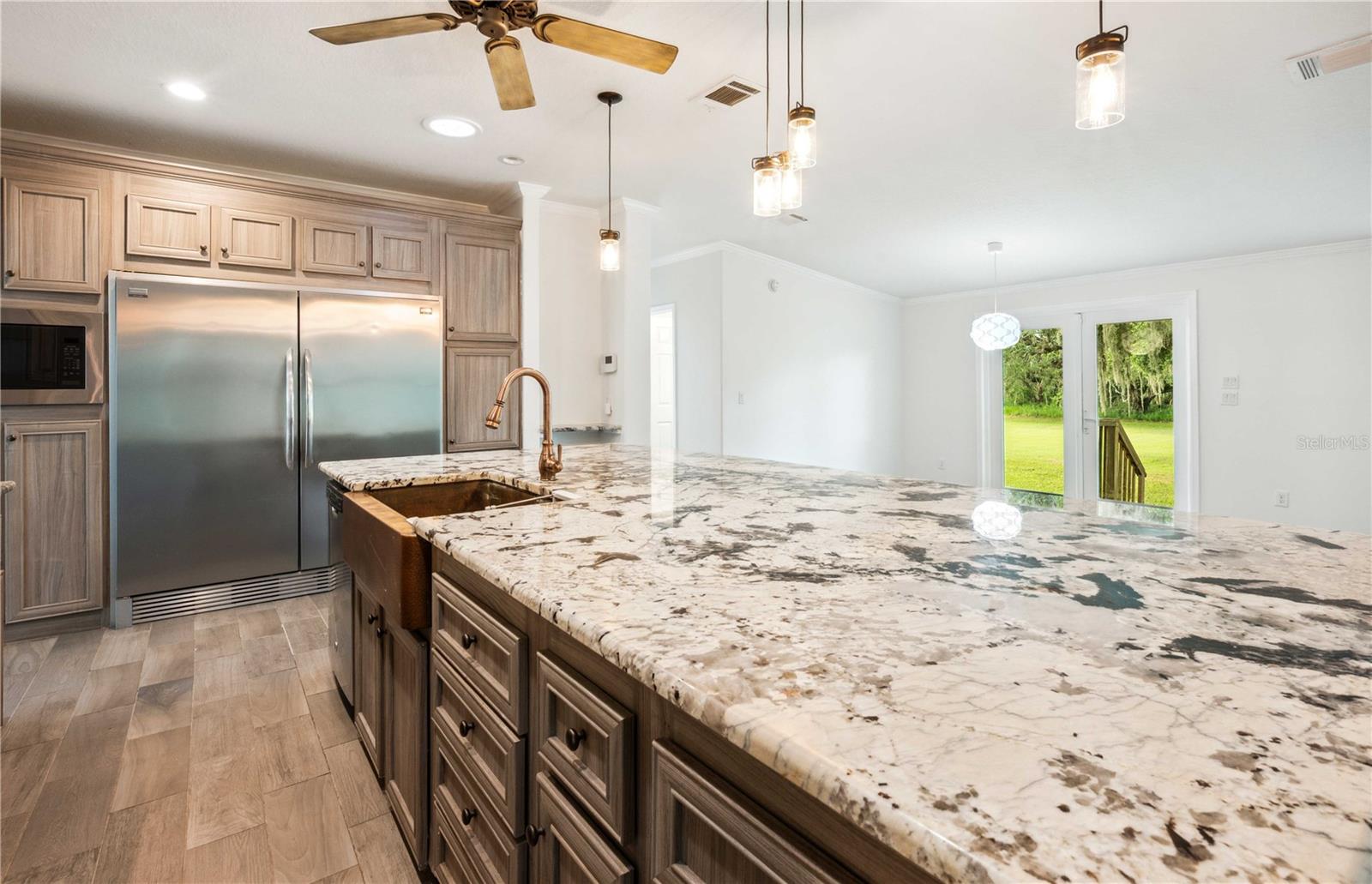 Oversized granite island provides ample space for cooking, entertaining, and meal prep.
