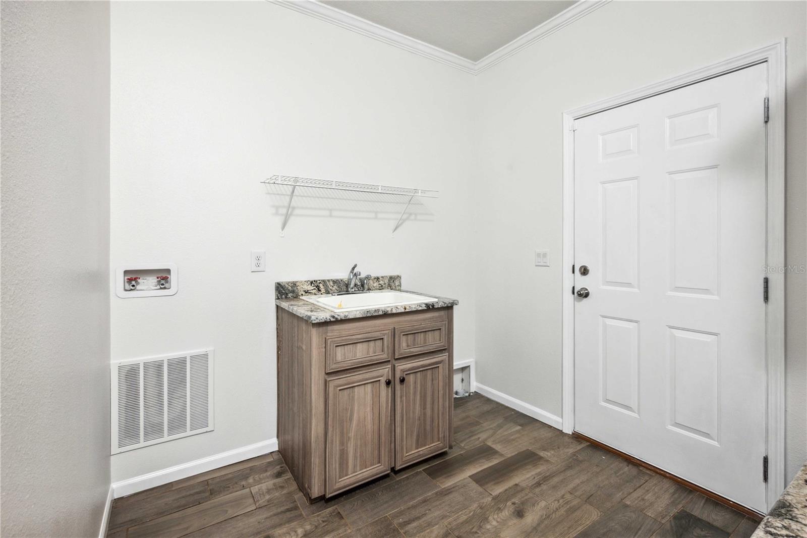 Laundry area with direct entry to the three-car attached garage.