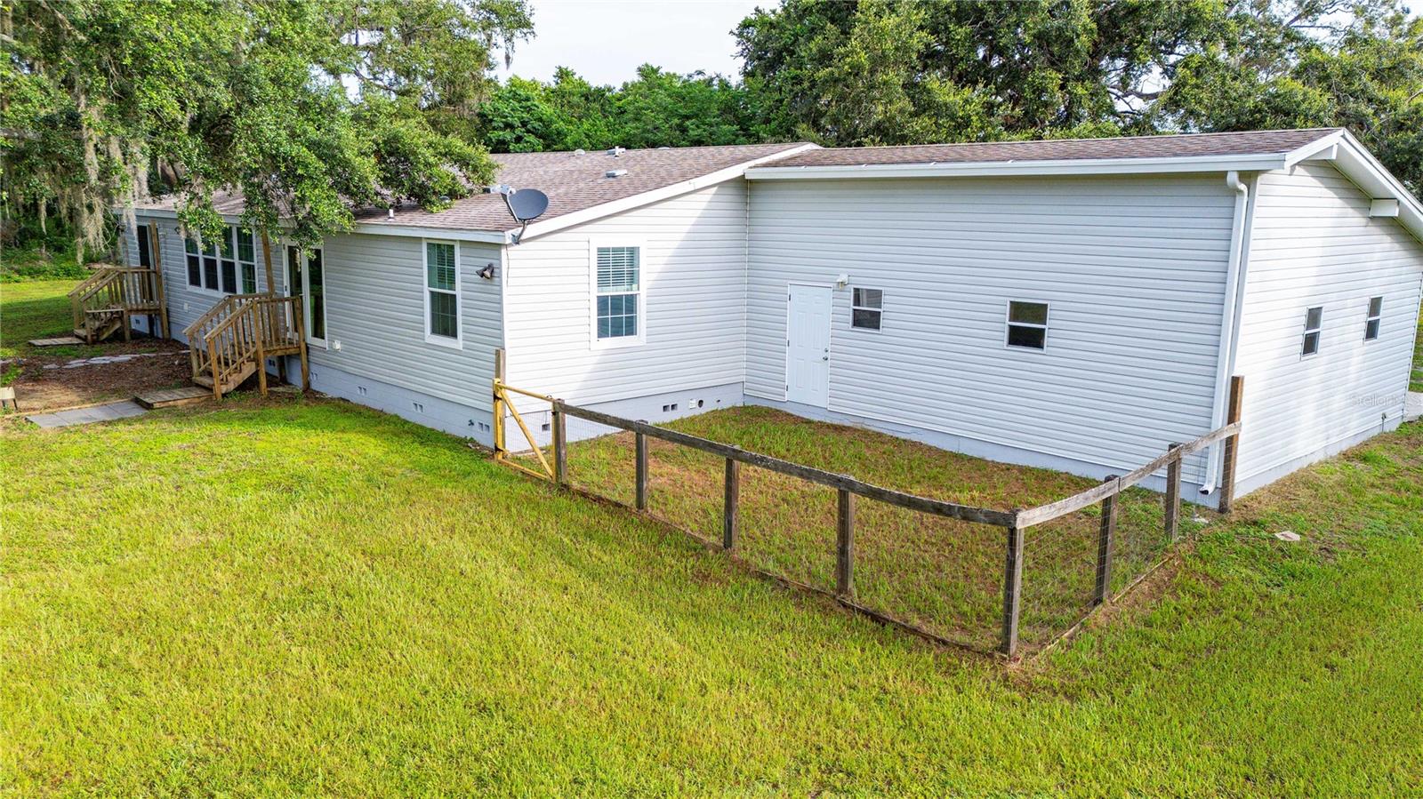 Fenced area for Fido conveniently located just outside the backyard garage door.