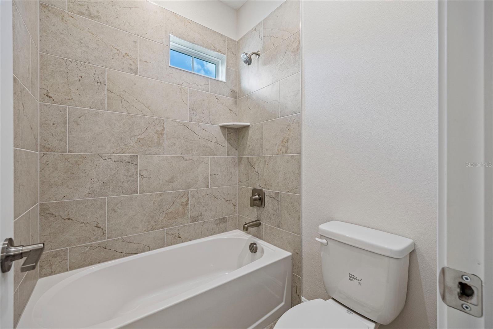 Shower and tub combo in the upstairs guest bathroom