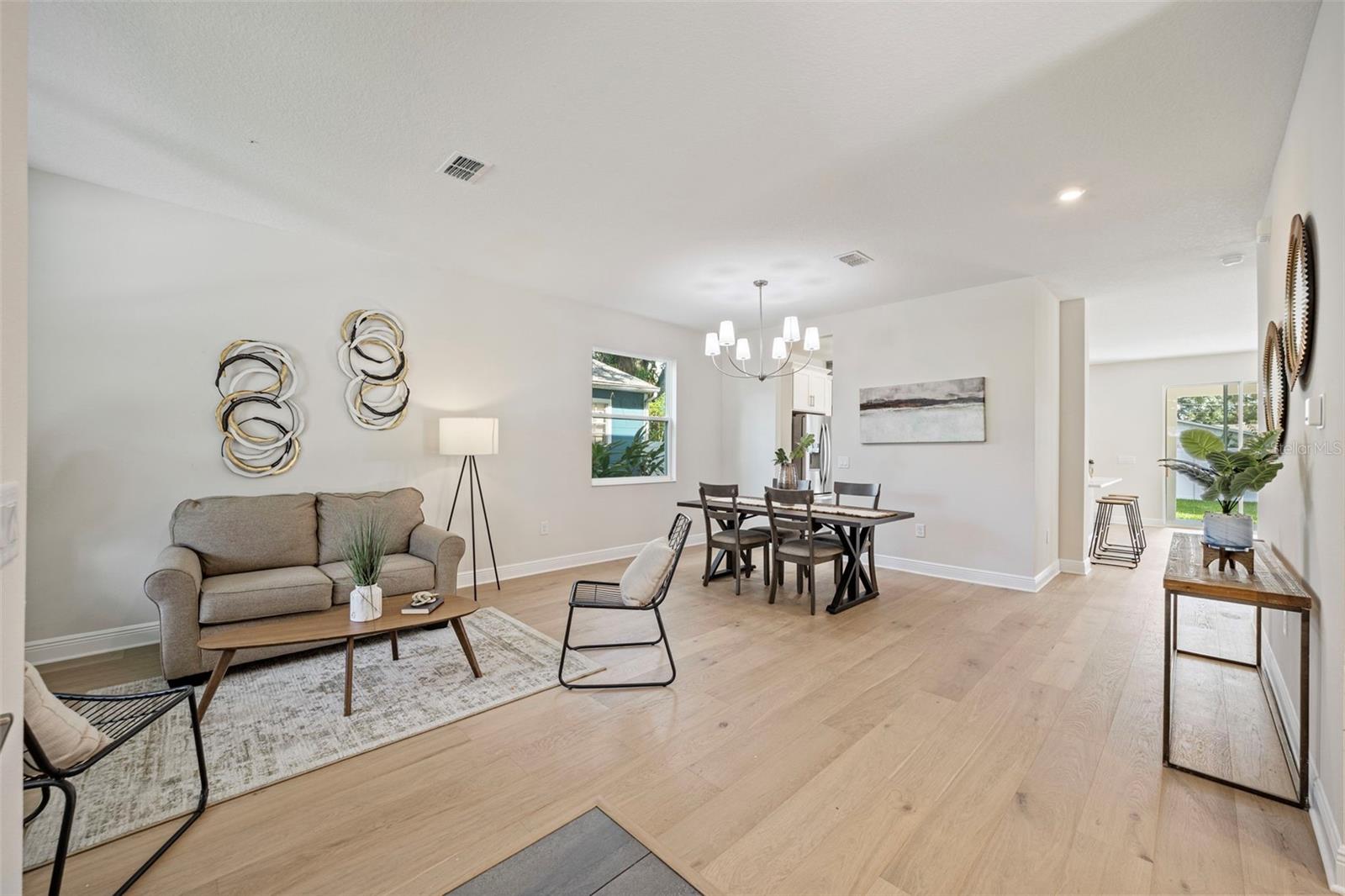 Upgraded dining room chandelier! Real, engineered hardwood floors throughout the home.