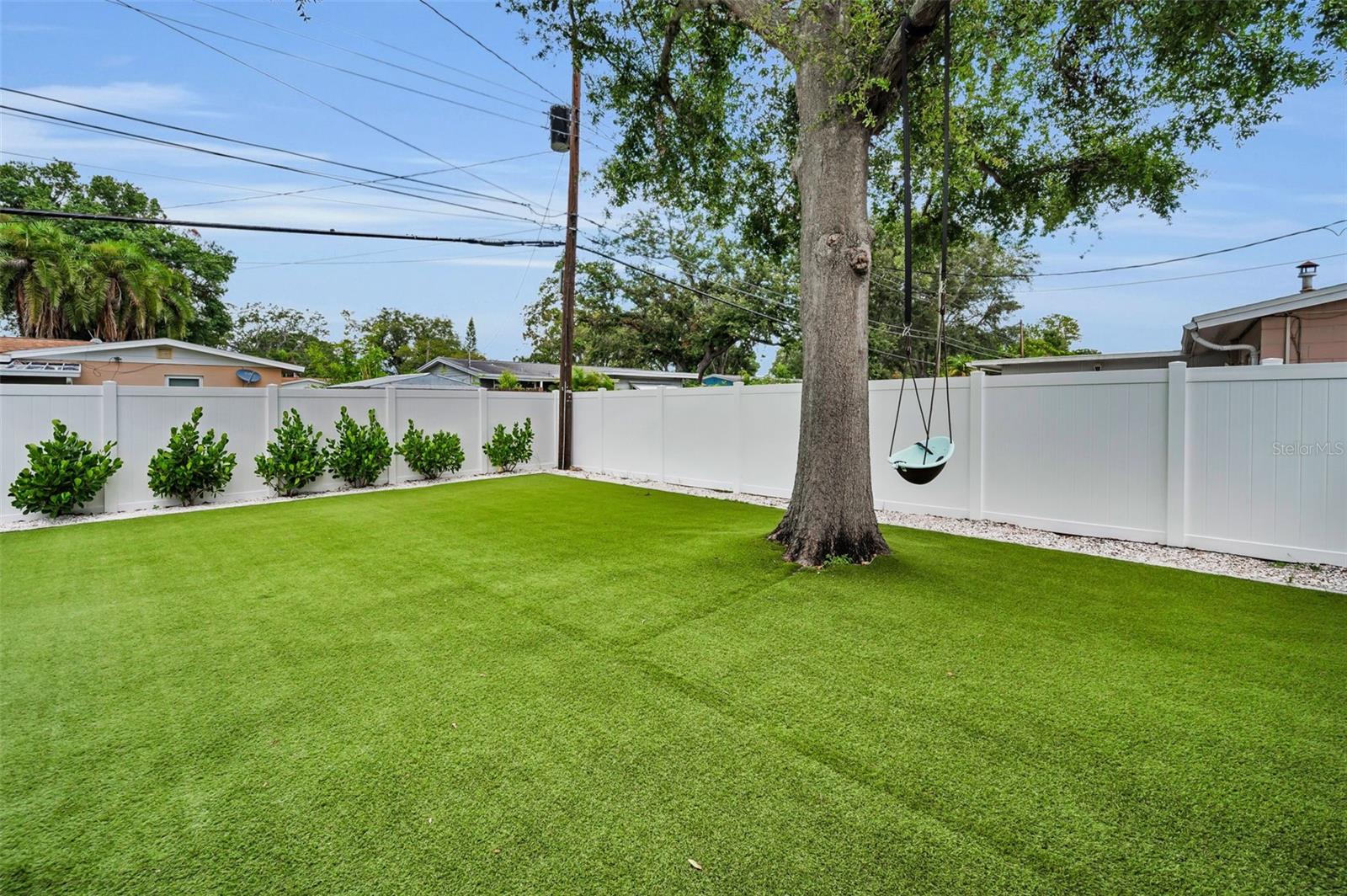 Artificial Turf Throughout Backyard and New Vinyl Fence