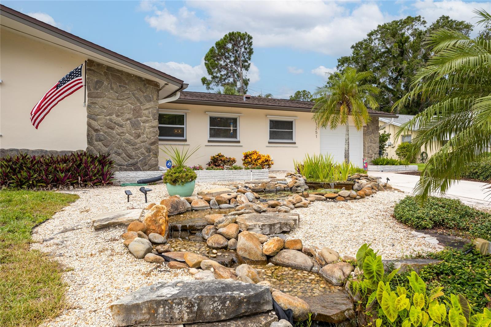 This beautiful pond feature is here to welcome you home!