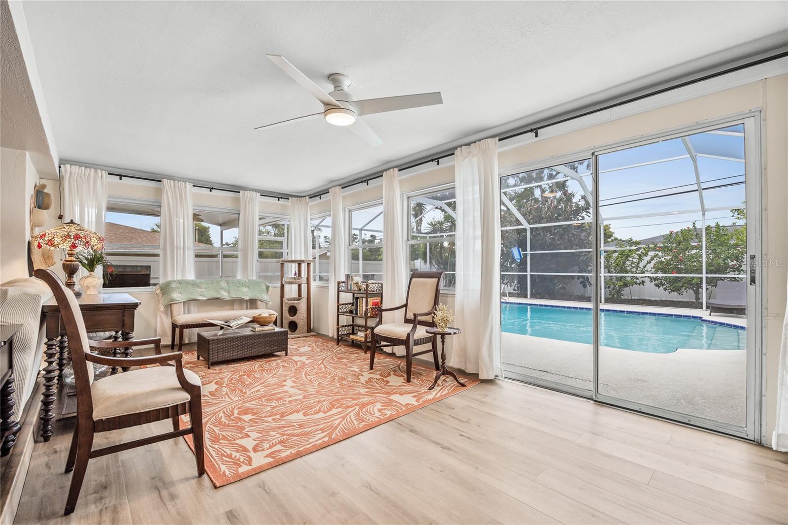 The Sunroom has the perfect view out to the screened lanai and pool area!    Perfect for indoor outdoor living!