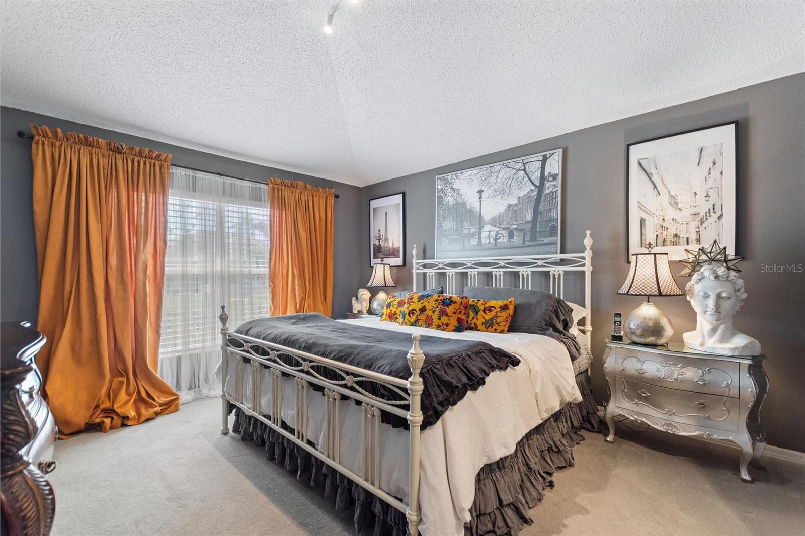 The primary bedroom is spacious, bright and open.  Notice the cathedral ceilings.
