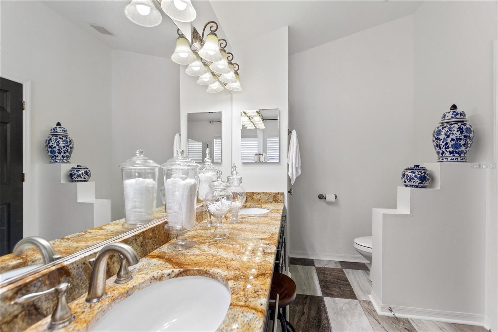 Dual sinks and abundance of lights complement the room.