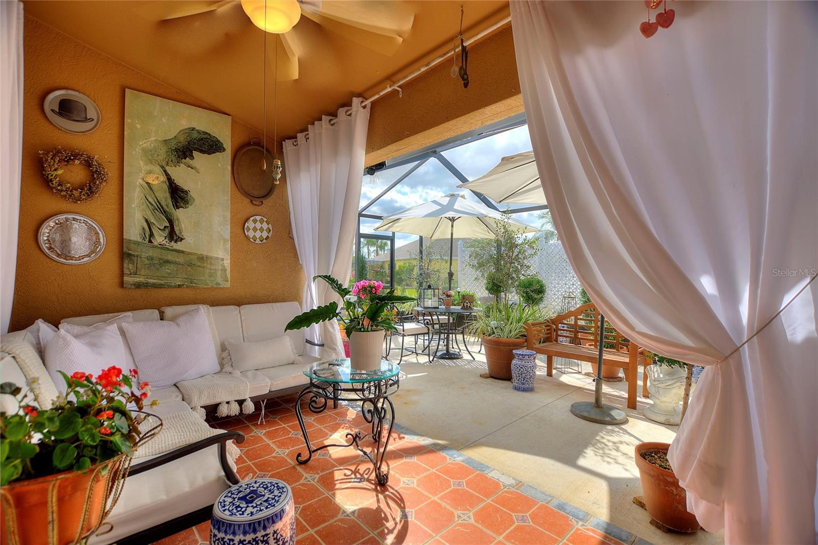This covered lanai area will keep you protected from the elements, no matter what is going on with Mother Nature.  Notice the custom tile work and fun colors!