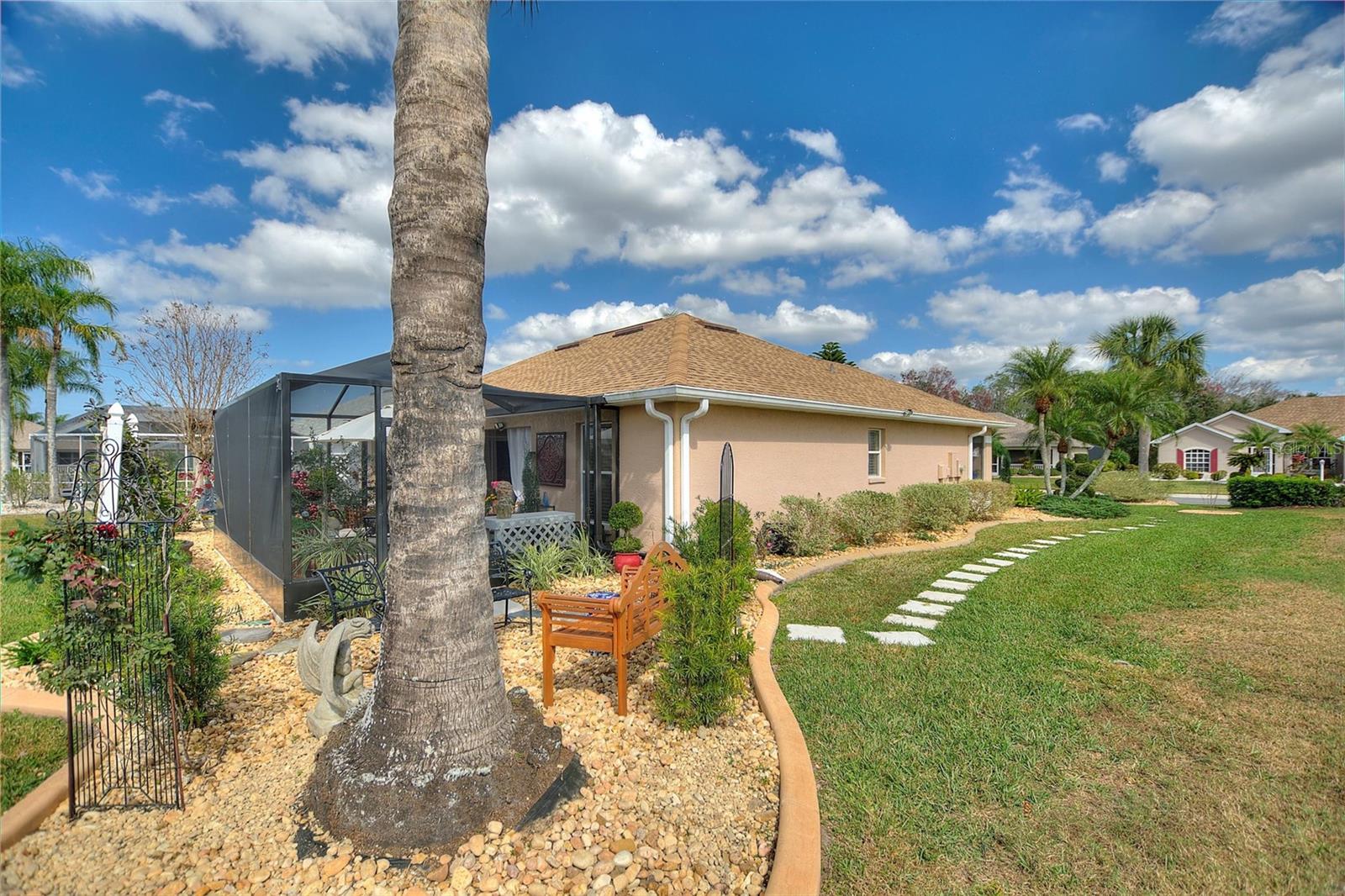 Manicured landscaping around the entire home with pavers and custom curbing