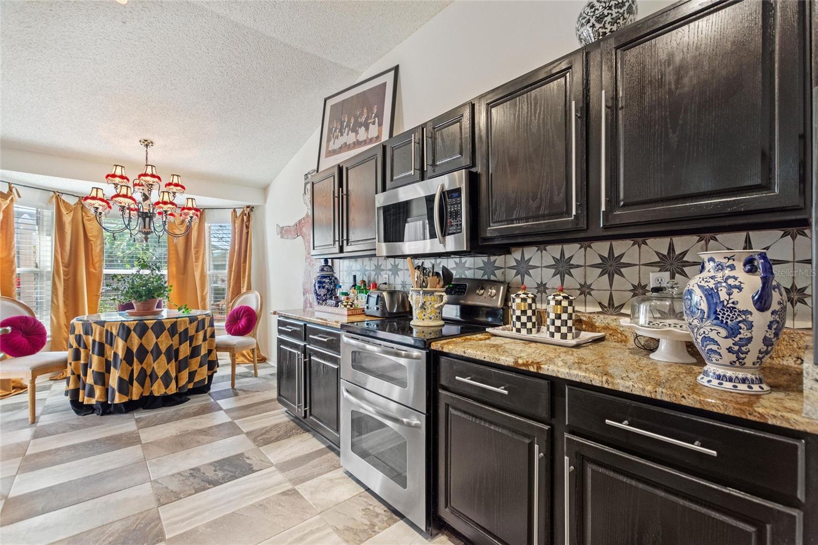 This eat in kitchen is large enough for multiple cooks and the large bay windows bring in lots of natural Florida sunshine.