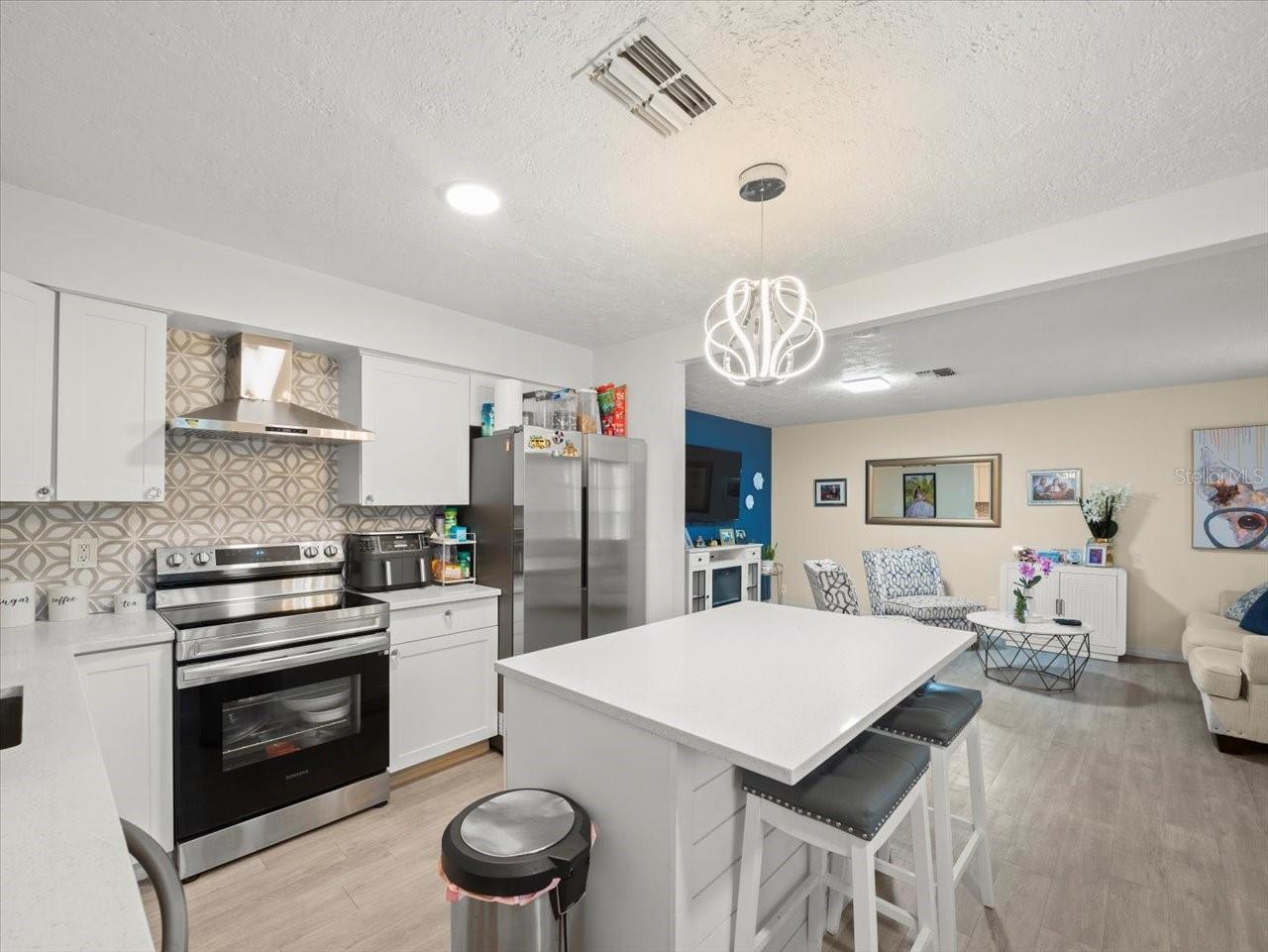 Kitchen with living room beyond.